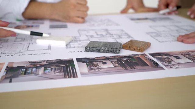 Close Up Of two Architects Discussing Plan Together At Desk With Blueprints. 4 k color gradation, decorative stone