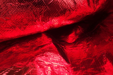 Creased plastic red polyethylene film texture