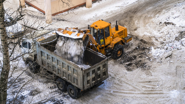 Snow loading by road machinery after heavy snowfall in residential block