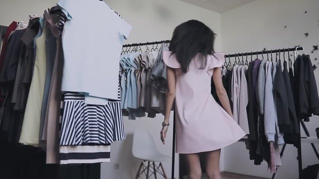 Woman posing in new dress in showroom