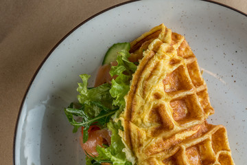 Nutritious and healthy breakfast - Omelet with vegetables, with salad leaves and red fish - salmon. The concept of proper nutrition