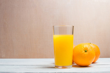 Sliced Orange and Juice Drink on White Wooden Background. Healthy Concept with Copyspace.