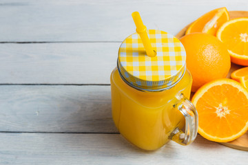 Sliced Orange and Juice Drink on White Wooden Background. Healthy Concept with Copyspace.