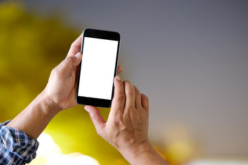 Close up male hand using a smart phone and night bokeh background.