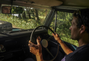 caucasian man driving a off road jeep