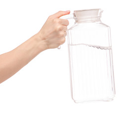 Transparent glass carafe with water in hand
