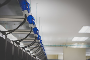 Blue emergency power plug, server room and black rack