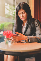 Business Concept.Young Asian businesswoman is working happily.Young businesswoman working in a cafe.Young businesswoman is relaxation in a coffee shop.