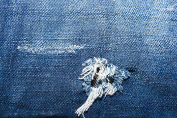 Blue Jean texture with a hole and threads 