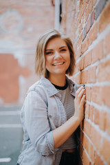 Cute Attractive Young Woman Modeling on Brick Wall