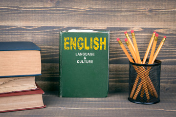 English language and culture concept. Book on a wooden background