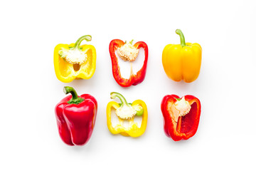 Layout of red and yellow sweet bell pepper slices on white background top view pattern