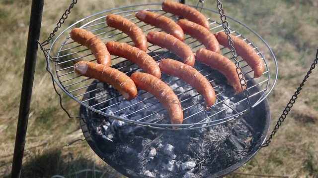 The sausage on the grill slowly baked up to later eat a great dinner.