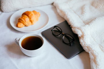 Coffee and croissant in bed