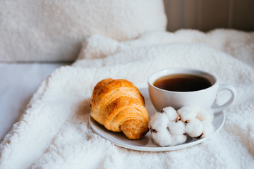 Coffee and croissant in bed
