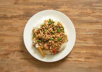 Thai food, Stir-fried pork with basil leaves on wooden background with space for text