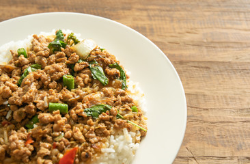 Thai food, Stir-fried pork with basil leaves on wooden background with space for text