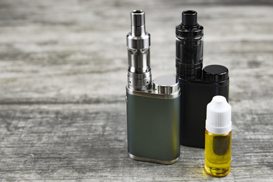 E - cigarette for vaping , technical devices.The liquid in the bottle 