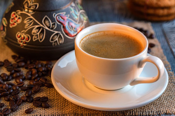 Cozy winter setting with cup of coffee and cezva