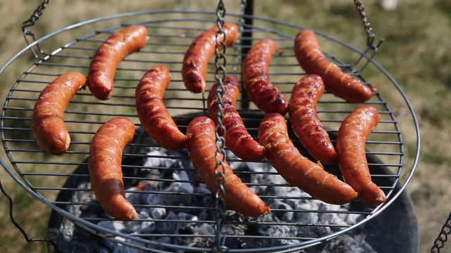 The sausage on the grill slowly baked up to later eat a great dinner.