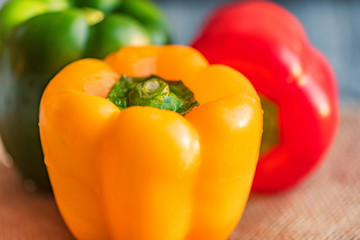 Variety of bell paprika peppers on cutting board