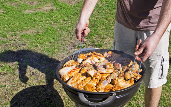 cook chicken wings on the grill on the grass