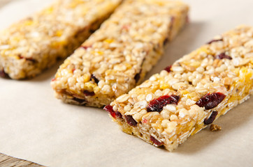 Granola bar with nuts, berries and oat flakes on a white background. Healthy food. Diet and vegetarian dish