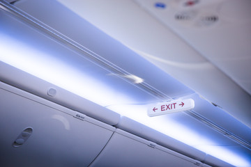 Exit sign in modern jet plane.