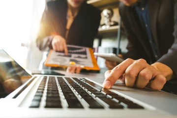 Business team present. professional investor working new start up project. Finance managers meeting.Digital tablet docking screen computer design smart phone using, in morning light
