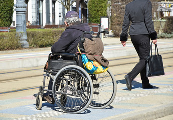 Old man in wheelchair on the street