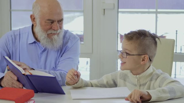 Grandson asks grandpa to help him with homework