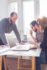 Fototapeta premium Group of young architects in a sunny office.