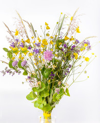Festive bouquet of yellow and purple wildflowers, herbs on a white background.