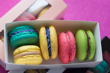 mix of macaroons in colored boxes