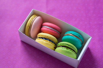 mix of macaroons in white boxes