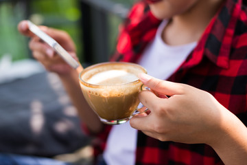 Closeup of female hands holding coffee