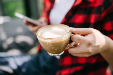 Closeup of female hands holding coffee
