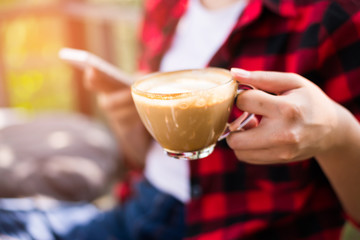 Closeup of female hands holding coffee