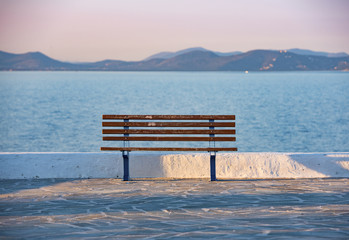 Fototapeta na wymiar sunset and bench in Rafina city with Aegean sea at the background