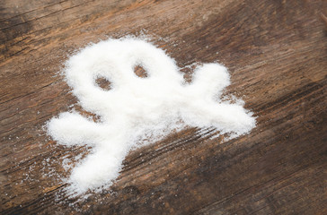 Skull made of granulated sugar. A conceptual photo illustrating the harm from consuming white refined sugar and products containing it