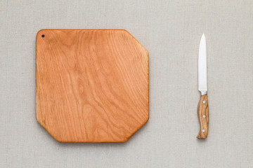Cherry wood cutting board and knife on linen, handmade wood cutting board	