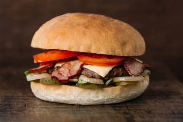 fresh tasty burger on wooden table