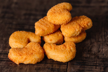 Fried chicken nuggets on wood background