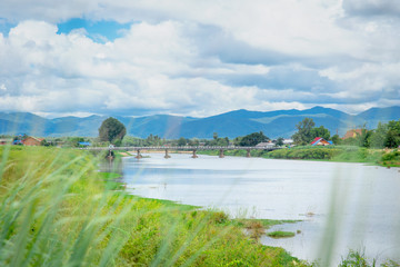 Fototapeta na wymiar Thai rural countryside beautiful landscape of river mountain blue sky and cloud