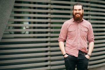 Portrait of smiling bearded man standing outside