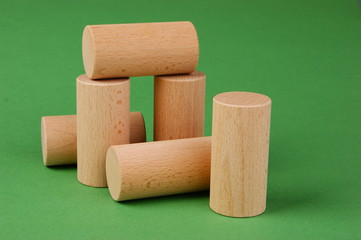 wooden geometric shapes on a green background