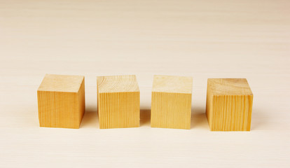 wooden geometric cube on a green background