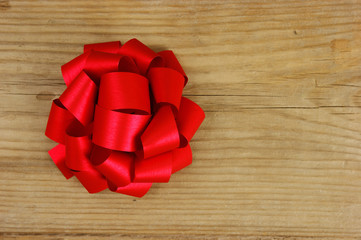 red bow on the old wooden background