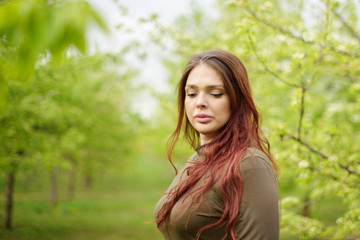 Fototapeta premium lovely girl in spring blossoming garden