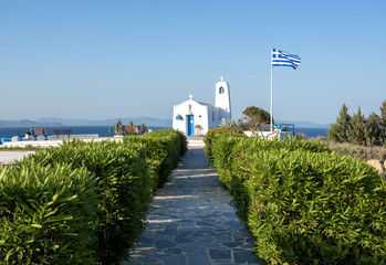 Obraz premium Typical greek place with a white small orthodox chapel dedicated to St Nikolaos. Rafina, Greece